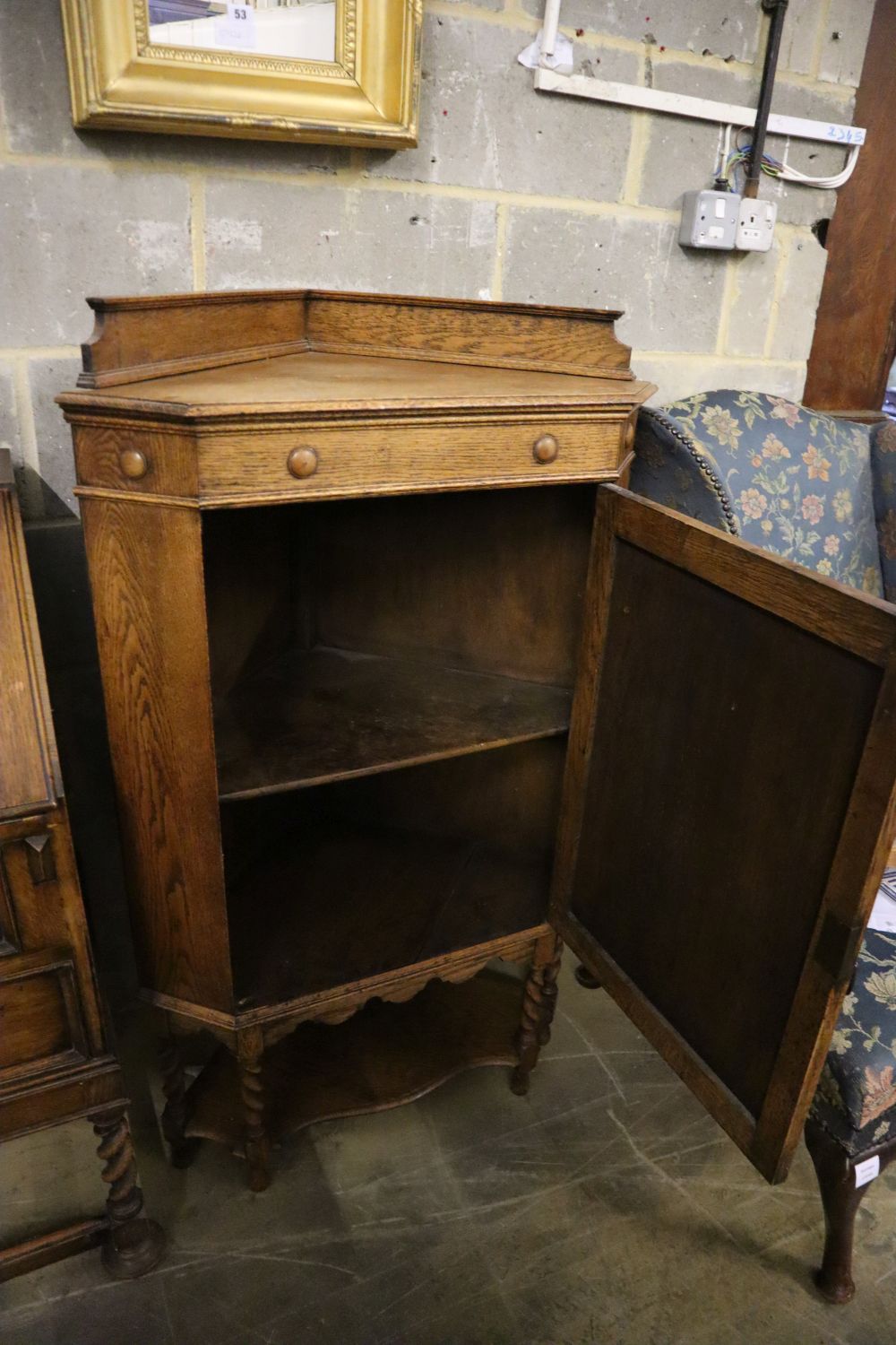 A 1920s panelled oak bureau, width 74cm, depth 46cm, height 103cm, together with a similar standing corner cabinet